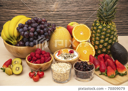 Group Fruits mixed with banana, orange, strawberry and nuts, concept health food and diet, vegetarian food in the top view on the wood table. 78809079