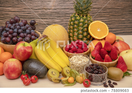 Group Fruits mixed with banana, orange, strawberry and nuts, concept health food and diet, vegetarian food in the top view on the wood table. 78809083