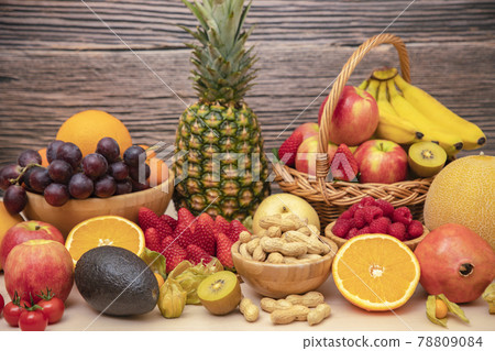 Group Fruits mixed with banana, orange, strawberry and nuts, concept health food and diet, vegetarian food in the top view on the wood table. 78809084