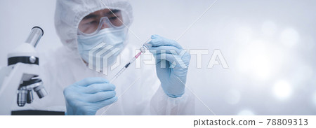 Doctor or scientist with a stethoscope holding COVID-19 vaccine, measles, coronavirus vaccine shot for diseases outbreak vaccination, vaccine Concept fight against virus covid-19 corona virus 78809313