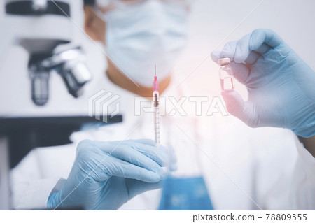 Doctor or scientist with a stethoscope holding COVID-19 vaccine, measles, coronavirus vaccine shot for diseases outbreak vaccination, vaccine Concept fight against virus covid-19 corona virus Doctor or scientist with a stethoscope holding COVID-19 vaccine, measles, coronavirus vaccine shot for diseases outbreak vaccination, vaccine Concept fight against virus covid-19 corona virus 78809355