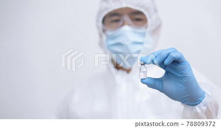 Close Up man doctor or scientist in uniform wearing face mask with a stethoscope holding COVID-19 vaccine, Healthcare And Medical concept, vaccine Concept fight against virus covid-19 corona virus Close Up man doctor or scientist in uniform wearing face mask with a stethoscope holding COVID-19 vaccine, Healthcare And Medical concept, vaccine Concept fight against virus covid-19 corona virus 78809372