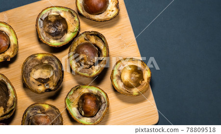 Overripe Avocado on wood Chipper dark background. Rotten Avocado Fruits in the kitchen on table. Unhelthy food concept. Stop wasting food. Copy space. 78809518