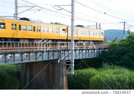Yellow JNR 115 series train bound for Okayama Station running on the Sanyo Main Line Ashimori River Railway Bridge 2 Kita-ku, Okayama City, Okayama Prefecture Yellow JNR 115 series train bound for Okayama Station running on the Sanyo Main Line Ashimori River Railway Bridge 2 Kita-ku, Okayama City, Okayama Prefecture 78814037