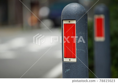 Safety pole along the sidewalk with red reflector Safety pole along the sidewalk with red reflector 78815023