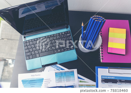 Office laptop business financial document chart and graph on wooden table with coffee cup. Flat lay notebook computer laptop on office desk. No people business graph chart mockup on business workspace 78818460