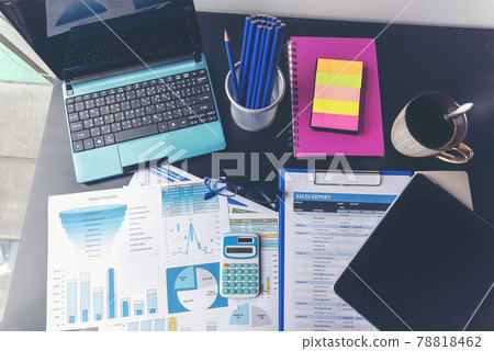 Office laptop business financial document chart and graph on wooden table with coffee cup. Flat lay notebook computer laptop on office desk. No people business graph chart mockup on business workspace Office laptop business financial document chart and graph on wooden table with coffee cup. Flat lay notebook computer laptop on office desk. No people business graph chart mockup on business workspace 78818462
