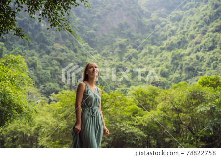 Woman tourist in Trang An Scenic Landscape Complex in Ninh Binh Province, Vietnam A UNESCO World Heritage Site. Resumption of tourism in Vietnam after quarantine Coronovirus COVID 19 Woman tourist in Trang An Scenic Landscape Complex in Ninh Binh Province, Vietnam A UNESCO World Heritage Site. Resumption of tourism in Vietnam after quarantine Coronovirus COVID 19 78822758