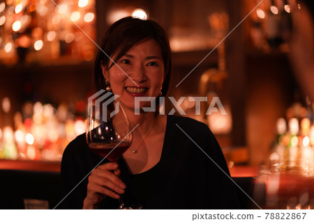 Woman drinking at the bar 78822867
