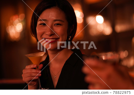 Woman drinking at the bar 78822975