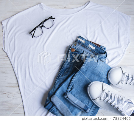 Stylish female clothes set. Woman outfit on wooden background Stylish female clothes set. Woman outfit on wooden background 78824405