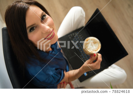 young happy business woman working at a laptop young happy business woman working at a laptop 78824618
