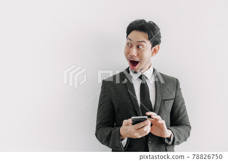 Wow and surprised face of businessman use trade application on the phone. 78826750