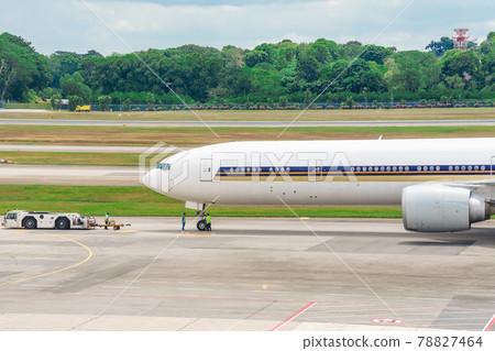 white passenger airplane is on the to runway of airport. 78827464