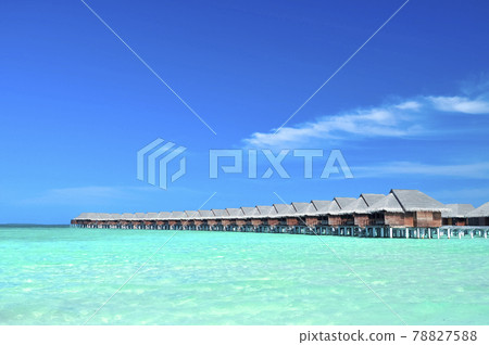 Maldivian water cottages and emerald green waters 78827588