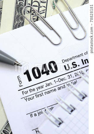 The pen, notebook and dollar bills is lies on the tax form 1040 U.S. Individual Income Tax Return. The time to pay taxes The pen, notebook and dollar bills is lies on the tax form 1040 U.S. Individual Income Tax Return. The time to pay taxes 78828181
