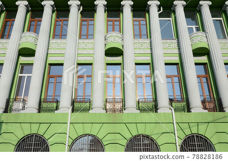 Restored old multi-storey building with antique columns, painted in green Restored old multi-storey building with antique columns, painted in green 78828186