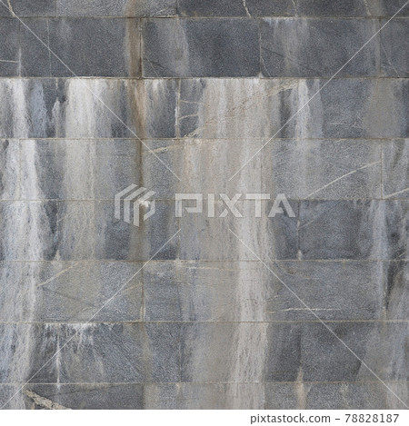 Background texture of a wall from an old gray granite tiles Background texture of a wall from an old gray granite tiles 78828187