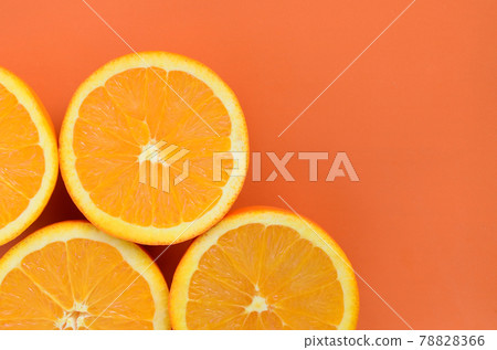 Top view of a several orange fruit slices on bright background in orange color. A saturated citrus texture image Top view of a several orange fruit slices on bright background in orange color. A saturated citrus texture image 78828366