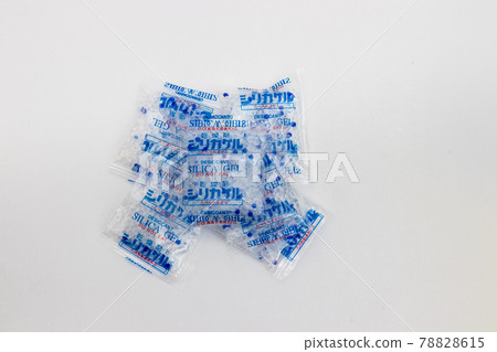 Desiccant silica on the pack. Closeup view. packet of silica gel buried in silica crystals. 78828615