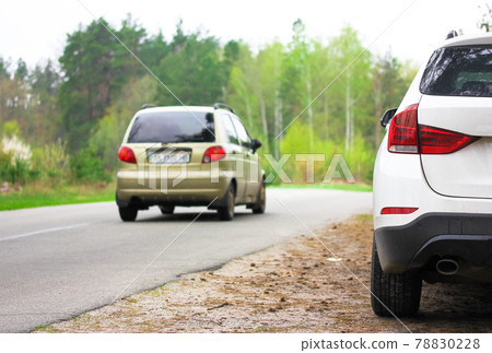 White SUV parked on a roadside in beautiful spring forest. Travel concept. 78830228