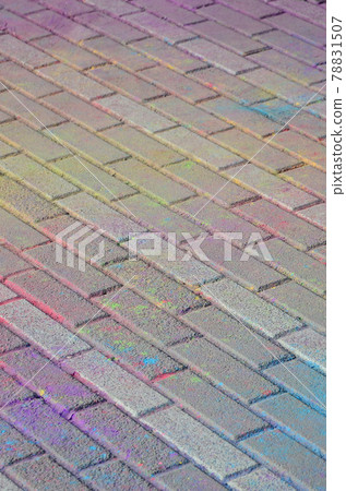 Multi colored paving slabs, powder coated with dry colors at the Holi festival 78831507