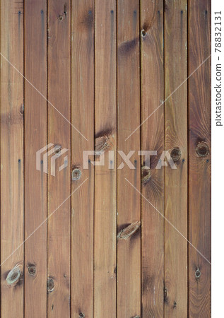Close up of brown wooden fence panels. Many vertical wooden planks 78832131