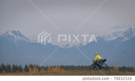 The woman travel on mixed terrain cycle touring with bikepacking. The traveler journey with bicycle bags. Sport tourism bikepacking. 78832528