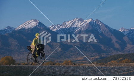 The woman travel on mixed terrain cycle touring with bikepacking. The traveler journey with bicycle bags. Sport tourism bikepacking. The woman travel on mixed terrain cycle touring with bikepacking. The traveler journey with bicycle bags. Sport tourism bikepacking. 78832538