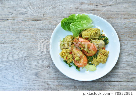 stir fried shrimp and squid with dolly fish in yellow curry couple egg on plate stir fried shrimp and squid with dolly fish in yellow curry couple egg on plate 78832891