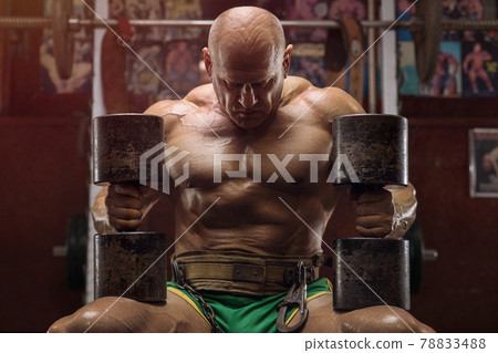 old fashion bodybuilder arm exercises in gym 78833488