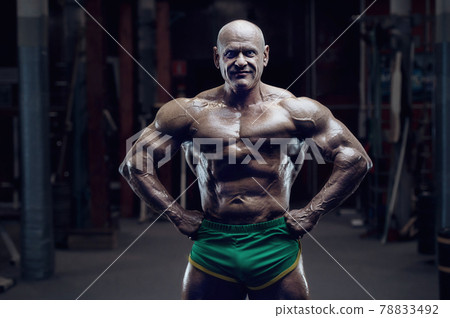 old fashion bodybuilder arm exercises in gym 78833492