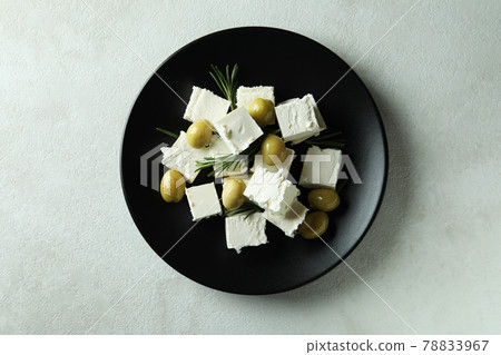 Plate with feta cheese, olives and rosemary on white textured background 78833967
