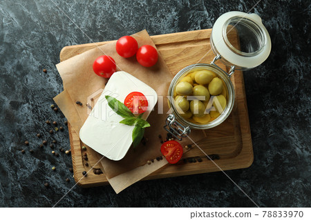 Concept of tasty food with feta cheese on black smokey background Concept of tasty food with feta cheese on black smokey background 78833970