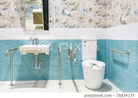 Toilet for the elderly and the disabled.It have two-sided handle for support the body and slip protection. Safety public toilet. Toilet for the elderly and the disabled.It have two-sided handle for support the body and slip protection. Safety public toilet. 78834135