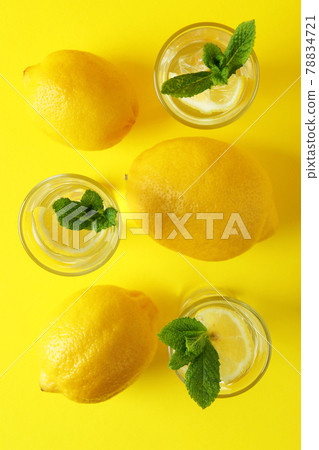Shots with lemon slice and mint on yellow background Shots with lemon slice and mint on yellow background 78834721