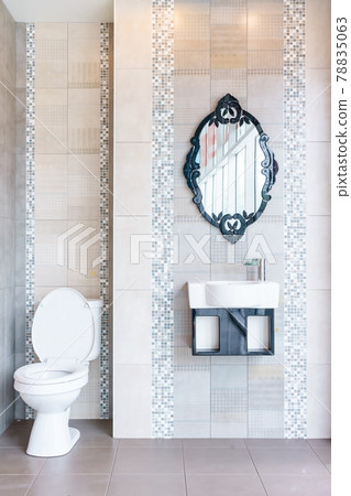 Modern bathroom interior with modern countertop basin, toilet and mirror 78835063