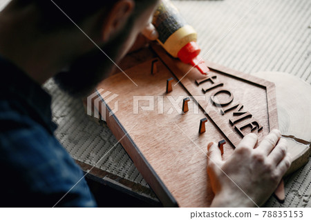 Woodworker applying glue to coards Woodworker applying glue to coards 78835153