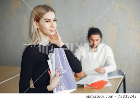 Stylish businessman with woman working at the office Stylish businessman with woman working at the office 78835242