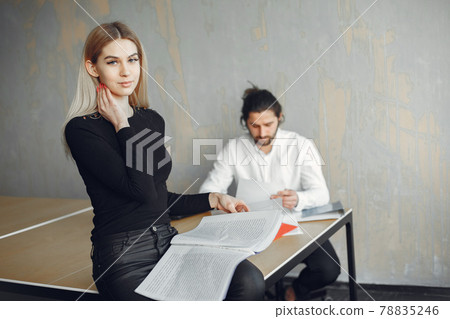 Stylish businessman with woman working at the office Stylish businessman with woman working at the office 78835246