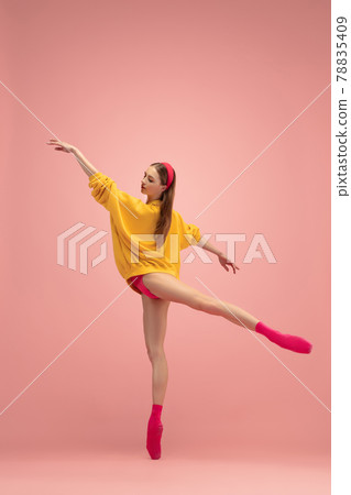 Portrait of young beautiful girl, female ballet dancer training isolated over pink background. Portrait of young beautiful girl, female ballet dancer training isolated over pink background. 78835409