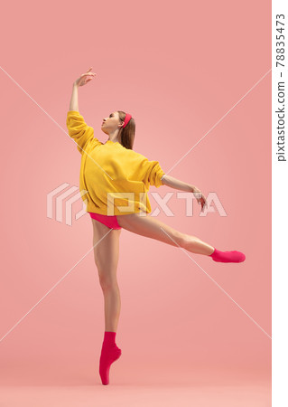 Flexible young beautiful girl, female ballet dancer training isolated over pink background. Flexible young beautiful girl, female ballet dancer training isolated over pink background. 78835473
