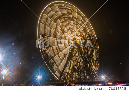 Ferris wheel in motion at the amusement park, night illumination. Long exposure 78835836