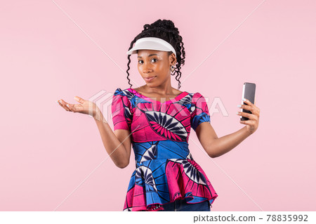 Beautiful afro american woman with visor shrugging at the camera: Technology and lifestyle concept. Beautiful afro american woman with visor shrugging at the camera: Technology and lifestyle concept. 78835992