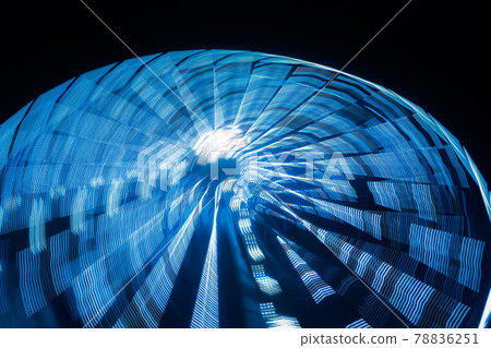 Ferris wheel in motion at the amusement park, night illumination. Long exposure Ferris wheel in motion at the amusement park, night illumination. Long exposure 78836251