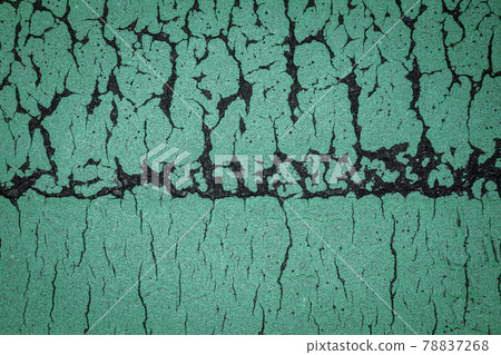 The green part of the asphalt road that has a line in the center and draws a mysterious pattern that is vertically asymmetrical The green part of the asphalt road that has a line in the center and draws a mysterious pattern that is vertically asymmetrical 78837268
