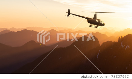 Black Helicopter flying over the Canadian Rocky Mountains. 78837952