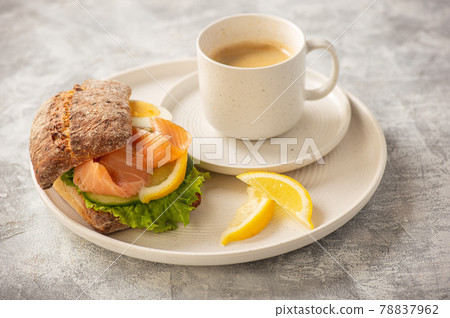 Sandwiches with smoked salmon, salad, cucumbers and eggs. 78837962