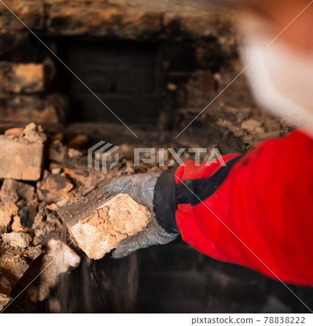 Old cooking stove, brick in soot, stove in the form of an arch, dismantling of the stove. Old cooking stove, brick in soot, stove in the form of an arch, dismantling of the stove. 78838222