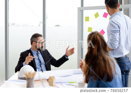Engineers team meeting for architectural project. architects discussing blueprint with construction manager in office worker conference site. Construction Concept Engineers team meeting for architectural project. architects discussing blueprint with construction manager in office worker conference site. Construction Concept 78838257